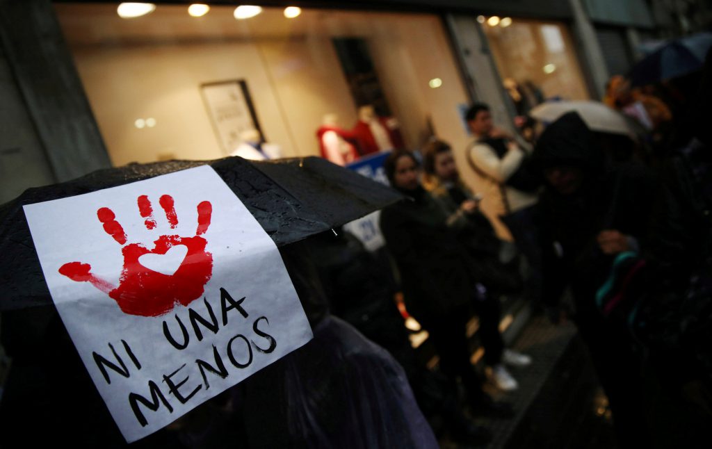 A woman carries a sign on her umbrella during a demonstration to demand policies to prevent gender-related violence in Buenos Aires
